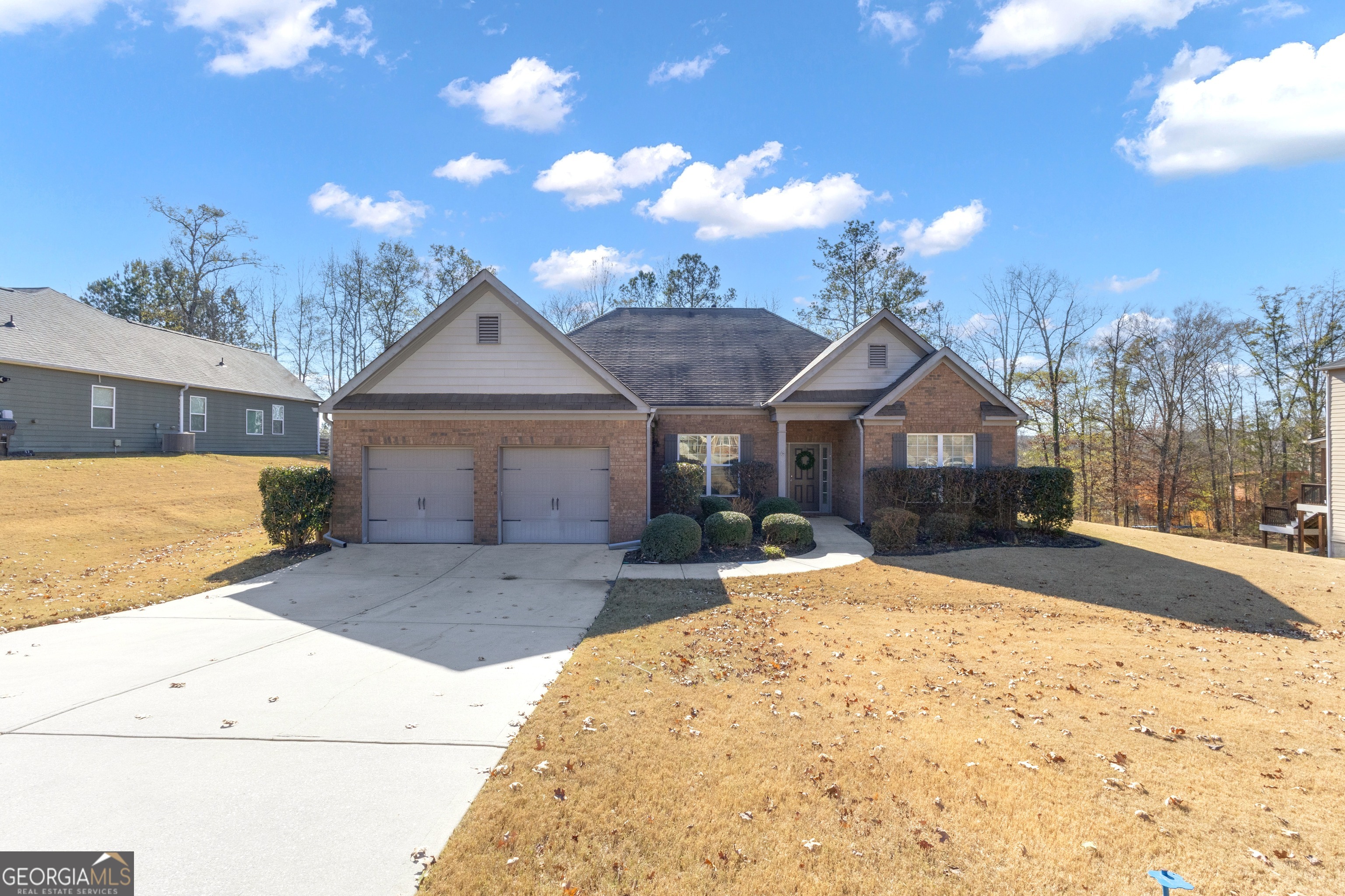 a front view of a house with a yard and garage