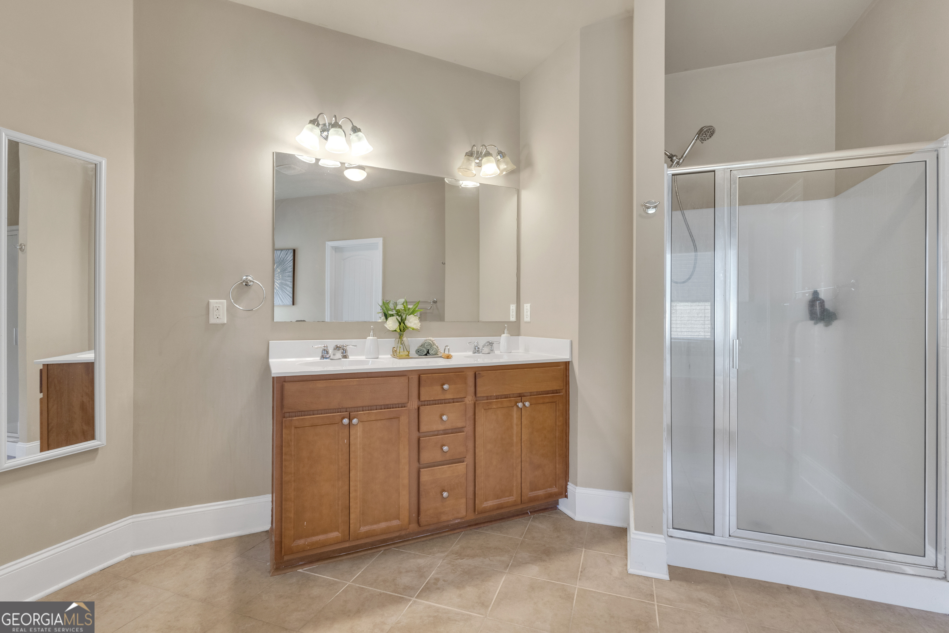 170 Savannah Drive Senoia, GA 30276 - Photo 13 of 60 a bathroom with a double vanity sink mirror and shower