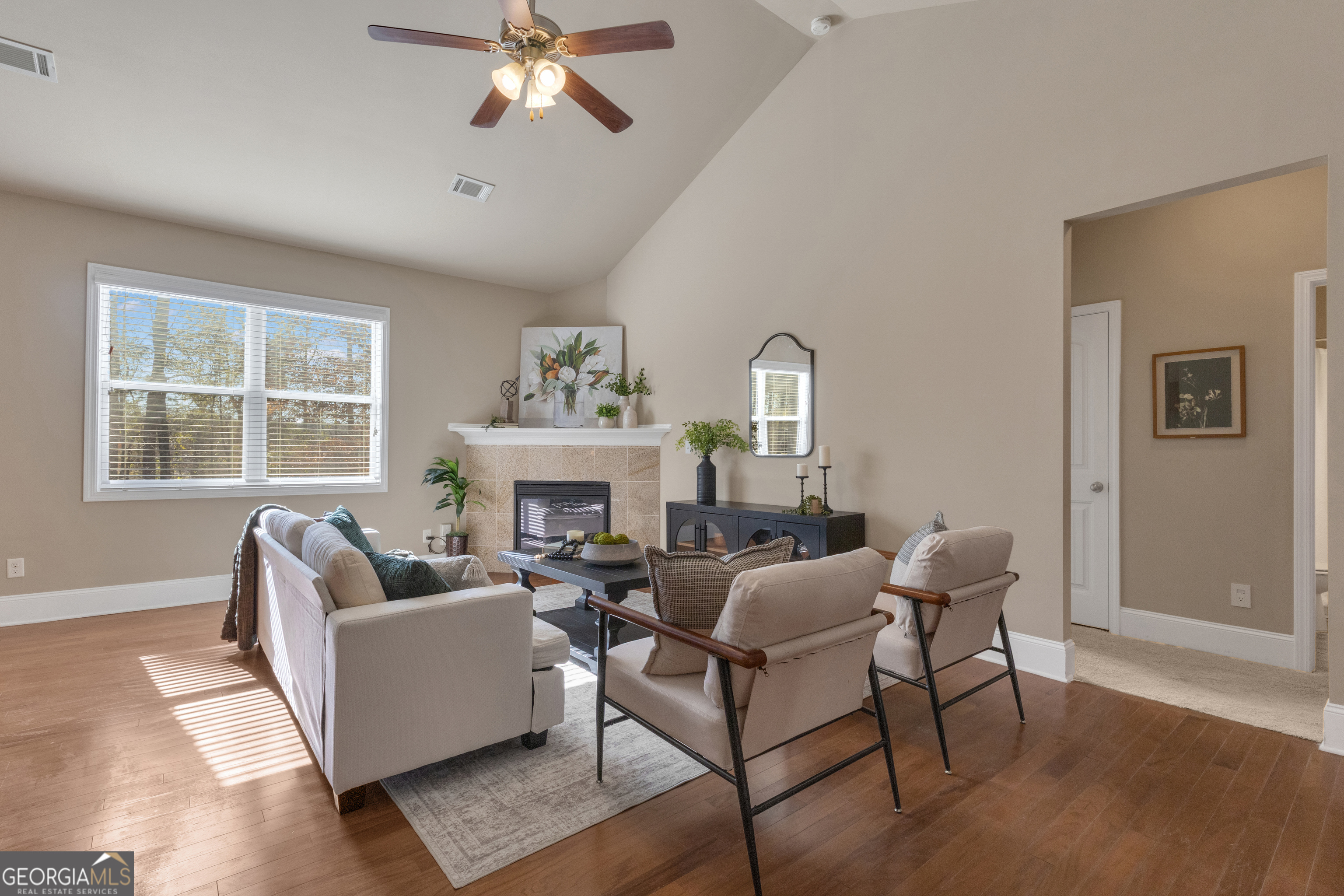 170 Savannah Drive Senoia, GA 30276 - Photo 20 of 60 a living room with furniture a fireplace and a large window
