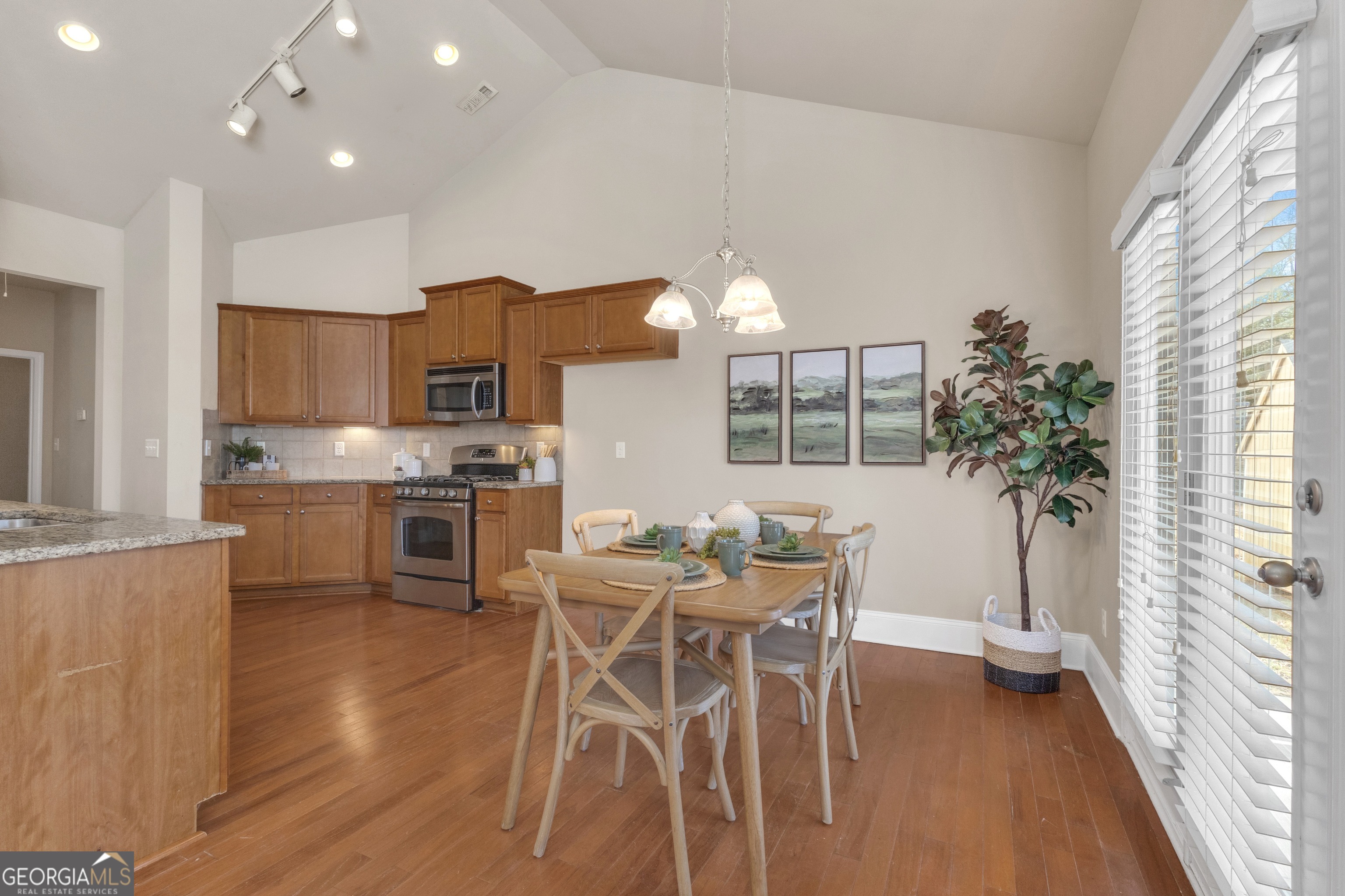 170 Savannah Drive Senoia, GA 30276 - Photo 24 of 60 a kitchen with stainless steel appliances a table and chairs in it