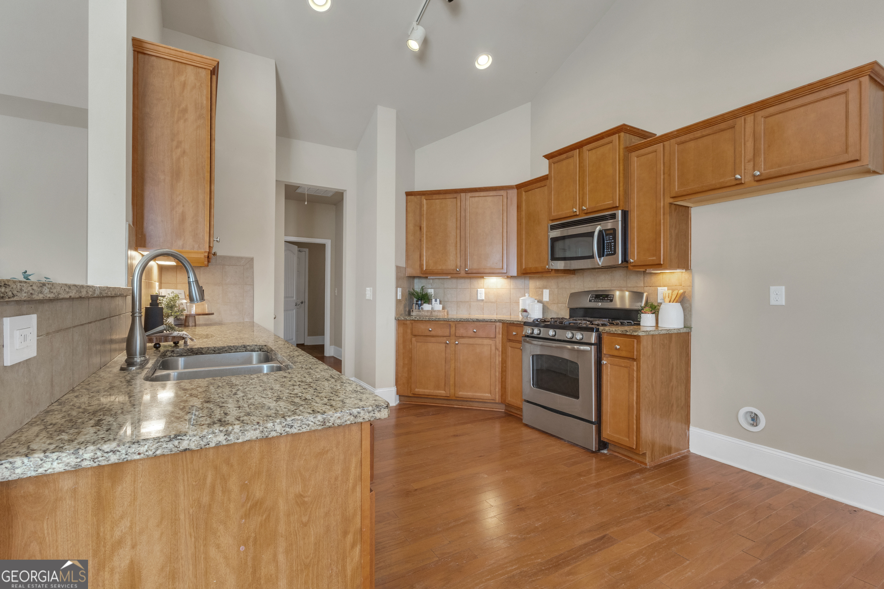 170 Savannah Drive Senoia, GA 30276 - Photo 28 of 60 a kitchen with stainless steel appliances granite countertop a sink stove and refrigerator
