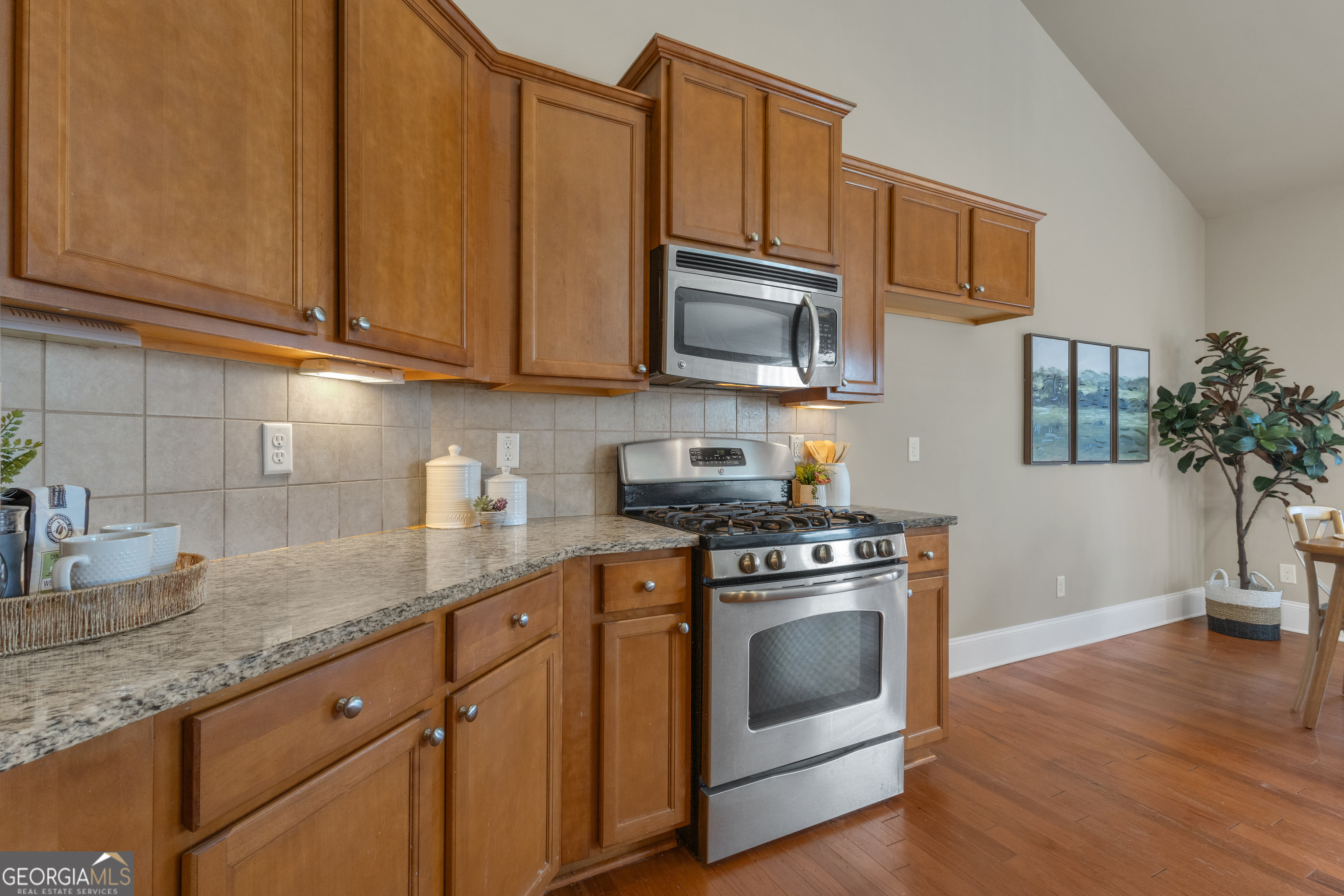 170 Savannah Drive Senoia, GA 30276 - Photo 29 of 60 a kitchen with stainless steel appliances granite countertop a sink a stove a microwave and cabinets