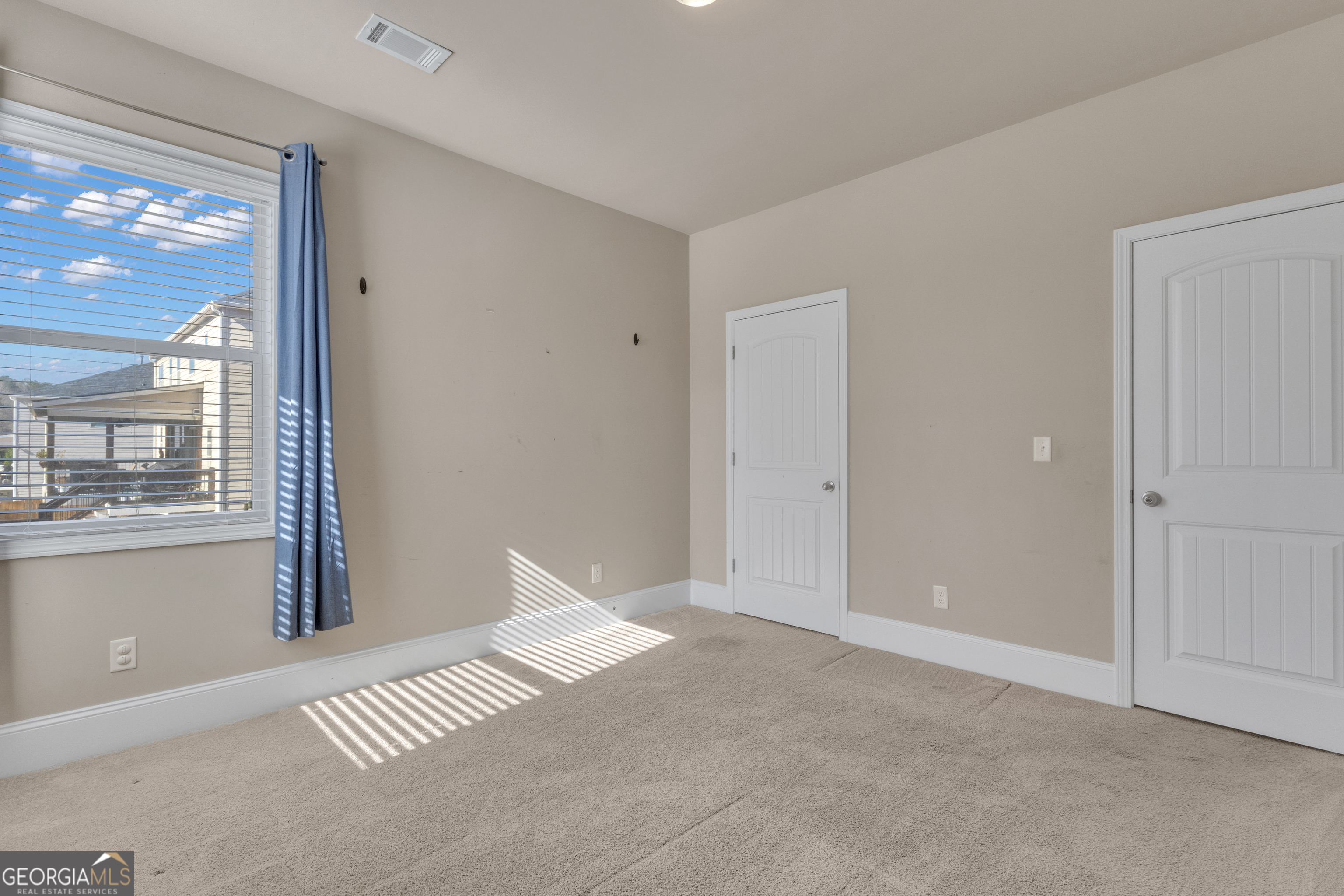 170 Savannah Drive Senoia, GA 30276 - Photo 33 of 60 a view of an empty room with window and a kitchen