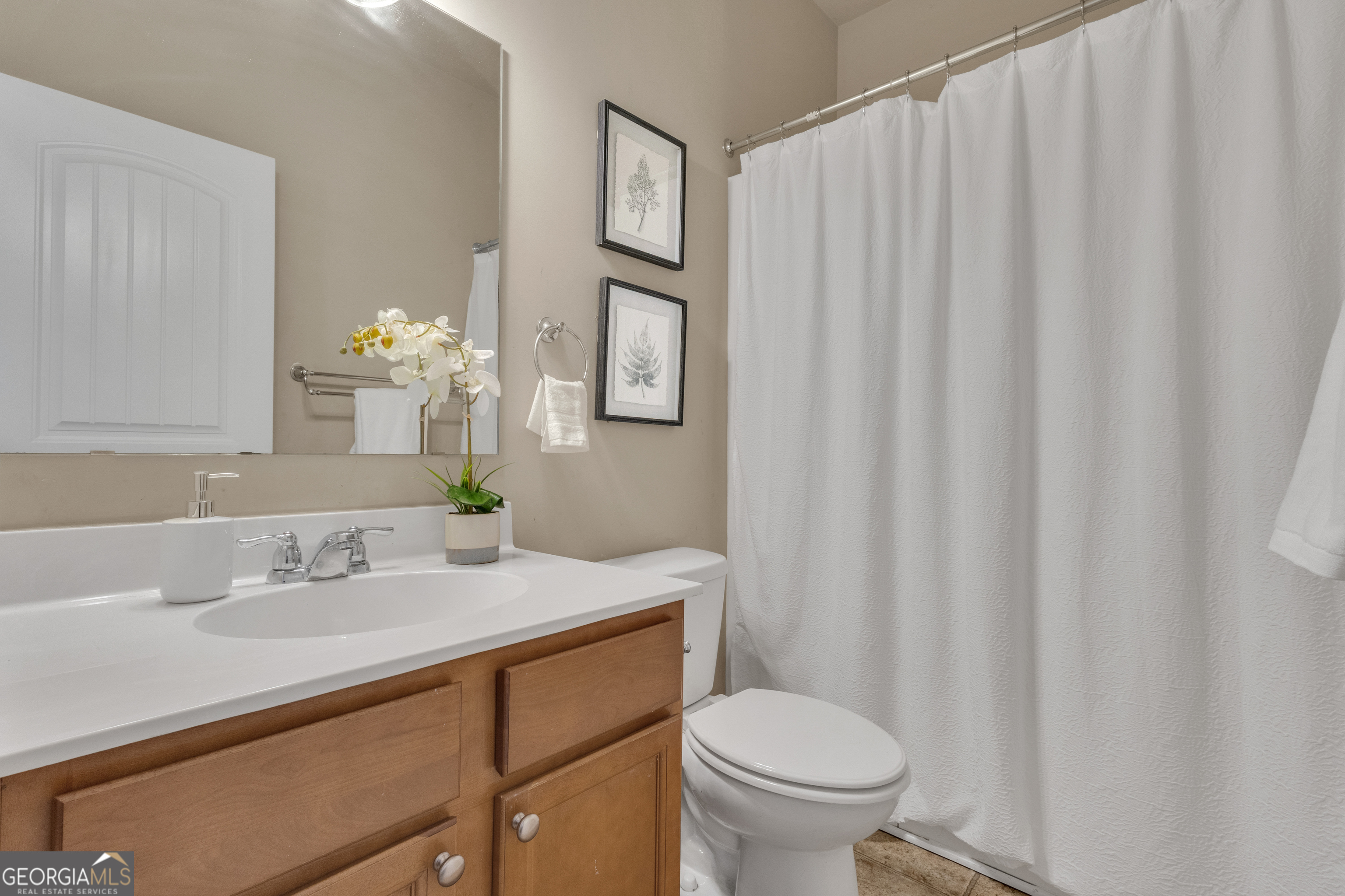 170 Savannah Drive Senoia, GA 30276 - Photo 34 of 60 a bathroom with a sink toilet and vanity