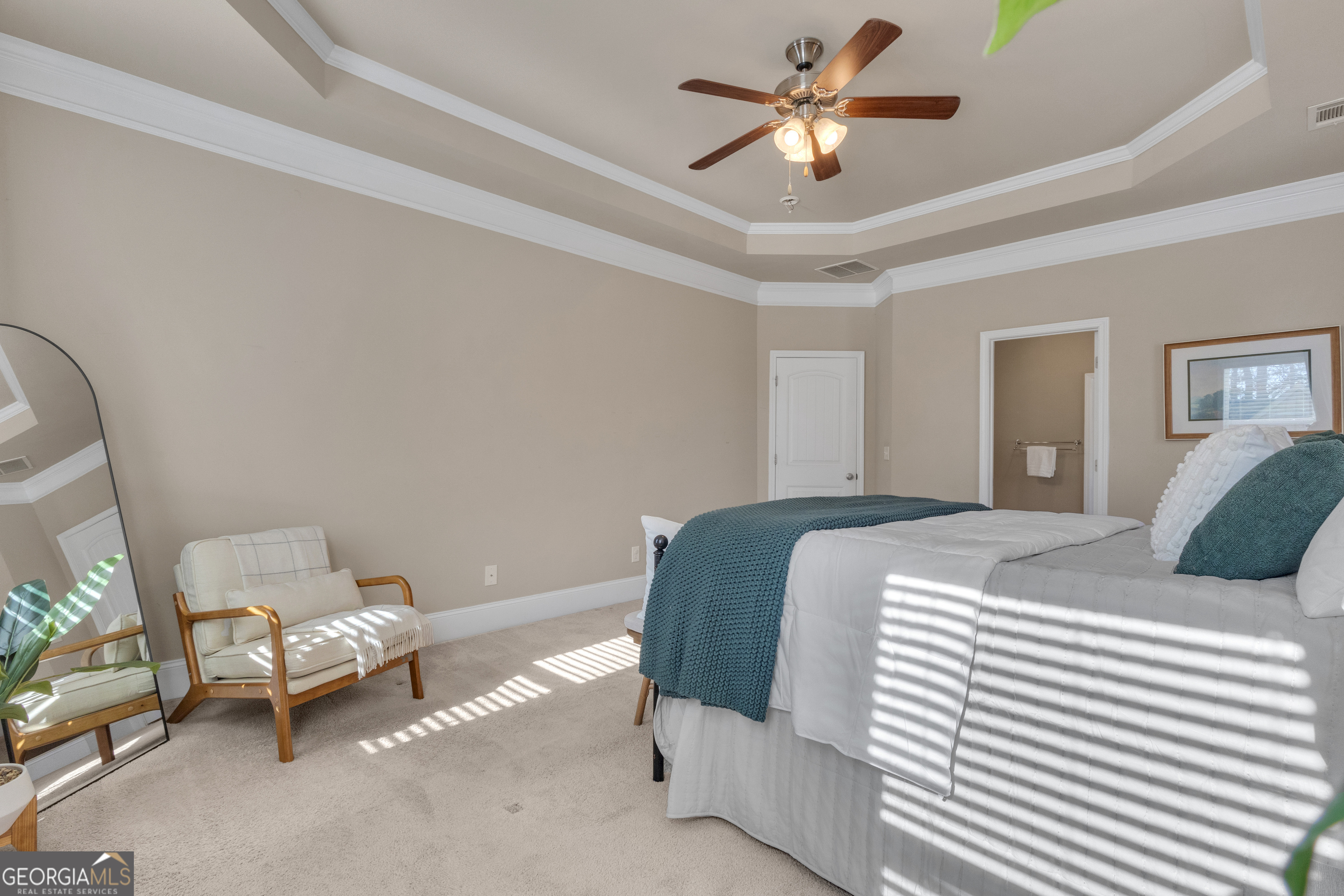 170 Savannah Drive Senoia, GA 30276 - Photo 9 of 60 a bedroom with a bed and a chandelier