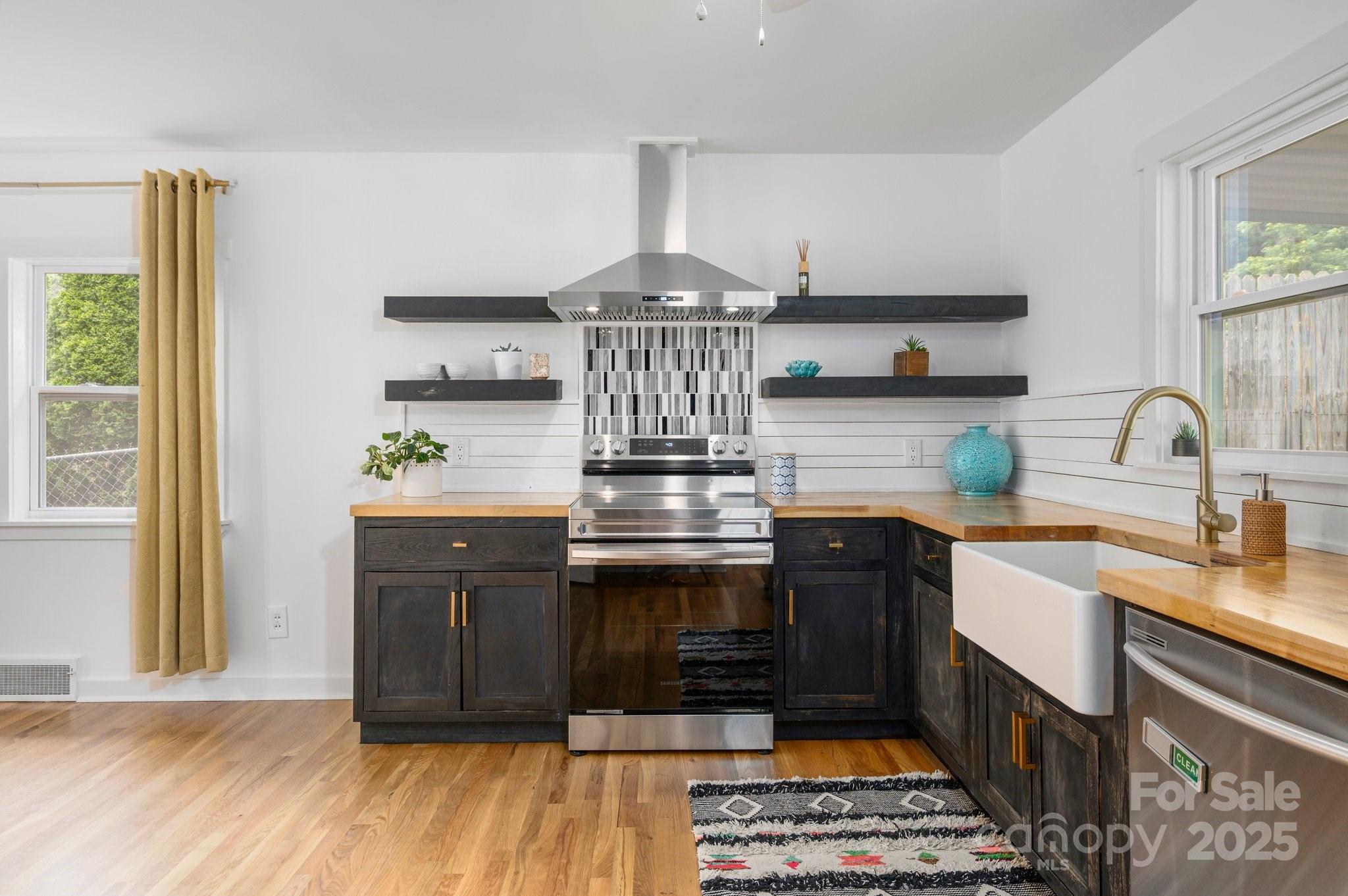 12 Canterbury Road Asheville, NC 28805 - Photo 15 of 44 a kitchen with stainless steel appliances granite countertop a stove and a sink