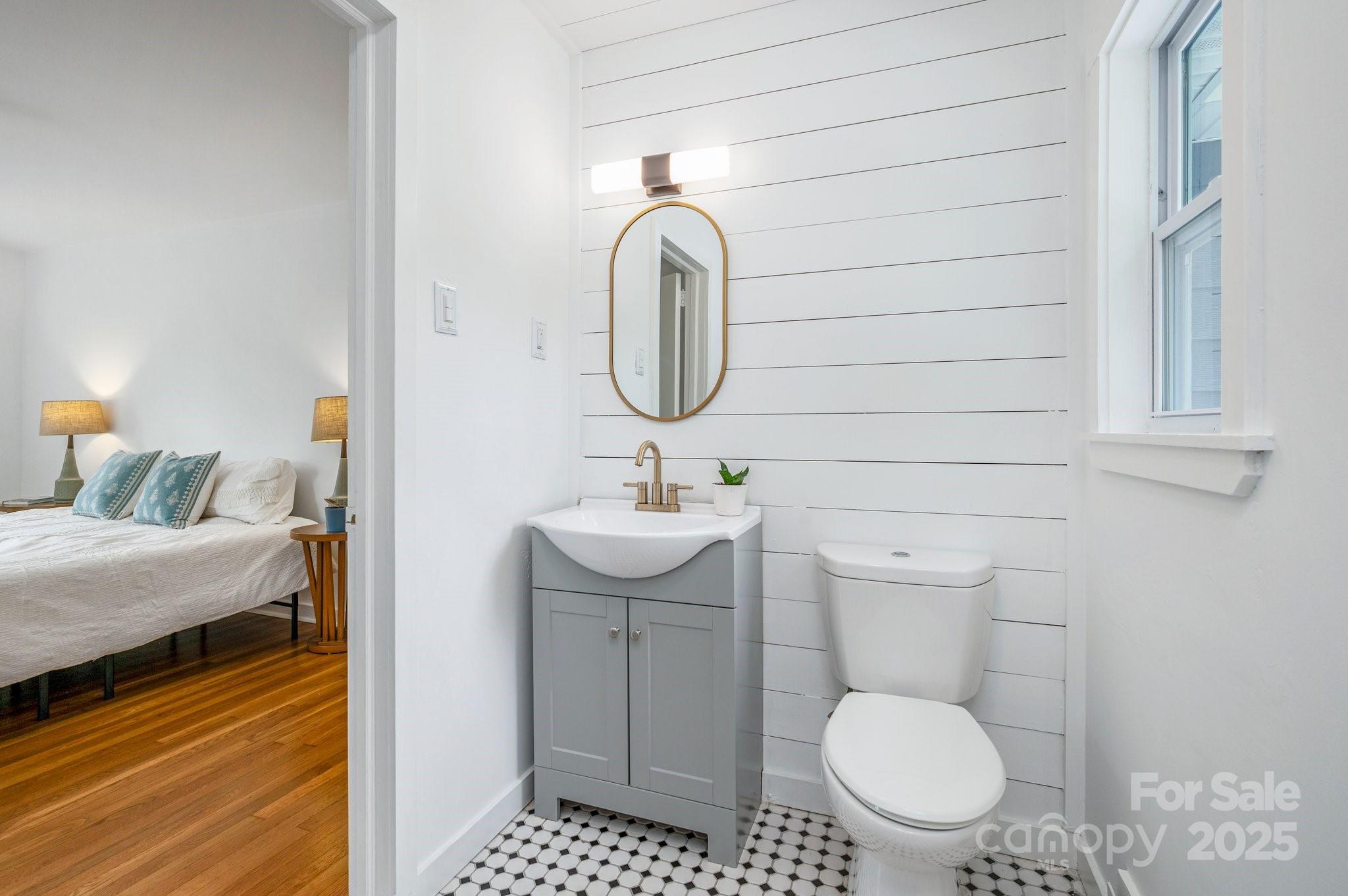 12 Canterbury Road Asheville, NC 28805 - Photo 18 of 44 a bathroom with a toilet a sink and mirror