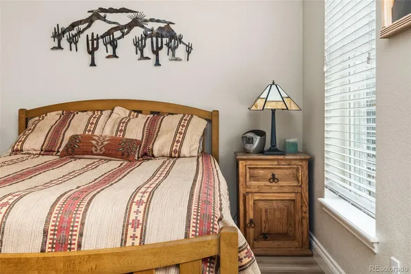 a bed sitting in a bedroom next to a window