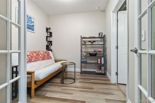 a view of a bedroom with wooden floor and closet