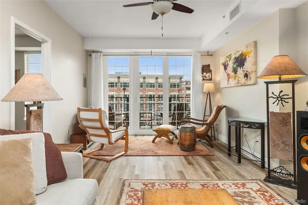a living room with furniture a rug and a chandelier