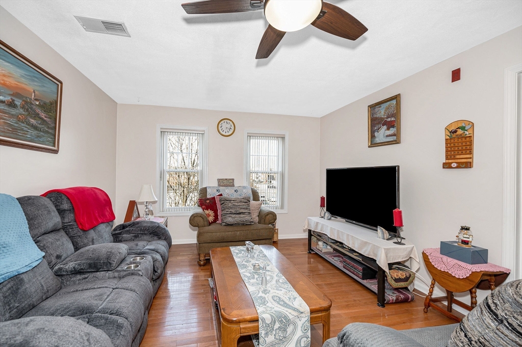 39 Broadway, Unit 305 Malden, MA 02148 - Photo 12 of 36 a living room with furniture and a flat screen tv