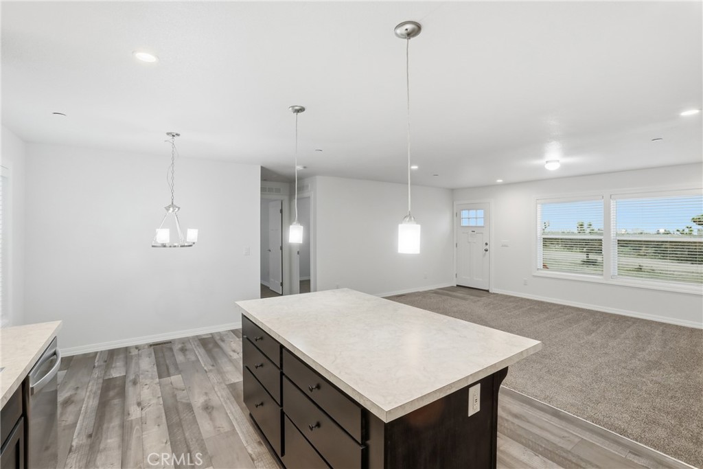 4237 Del Rosa Road Phelan, CA 92371 - Photo 14 of 37 a view of a kitchen island a sink wooden floor and a window