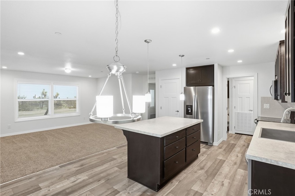 4237 Del Rosa Road Phelan, CA 92371 - Photo 15 of 37 a large kitchen with a large counter top a sink stainless steel appliances and cabinets