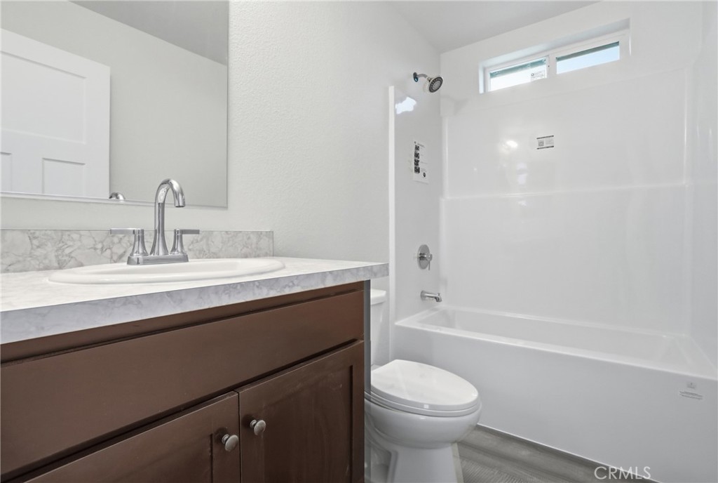 4237 Del Rosa Road Phelan, CA 92371 - Photo 20 of 37 a bathroom with a sink a toilet and shower