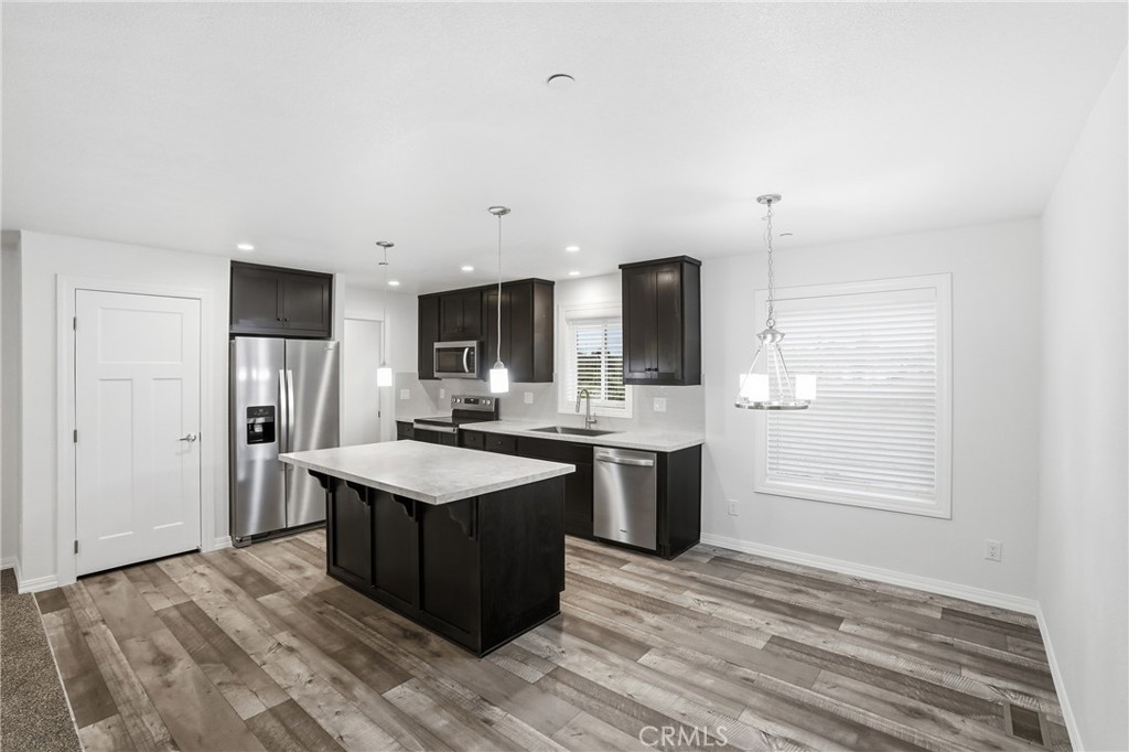 4237 Del Rosa Road Phelan, CA 92371 - Photo 3 of 37 a kitchen with stainless steel appliances granite countertop a sink stove and refrigerator