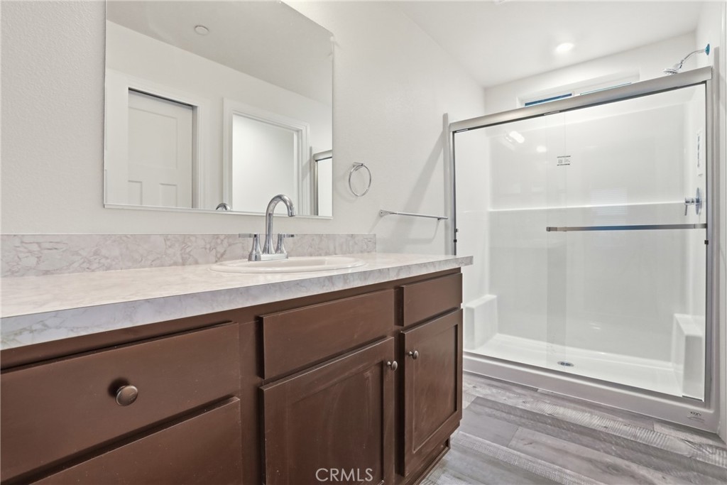 4237 Del Rosa Road Phelan, CA 92371 - Photo 4 of 37 a bathroom with a shower sink and mirror