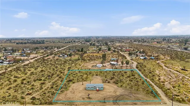 an aerial view of a residential houses with city view