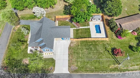 an aerial view of a house with a yard and garden