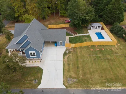 an aerial view of a house with swimming pool