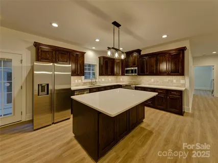 a bathroom with a granite countertop toilet a sink and a mirror