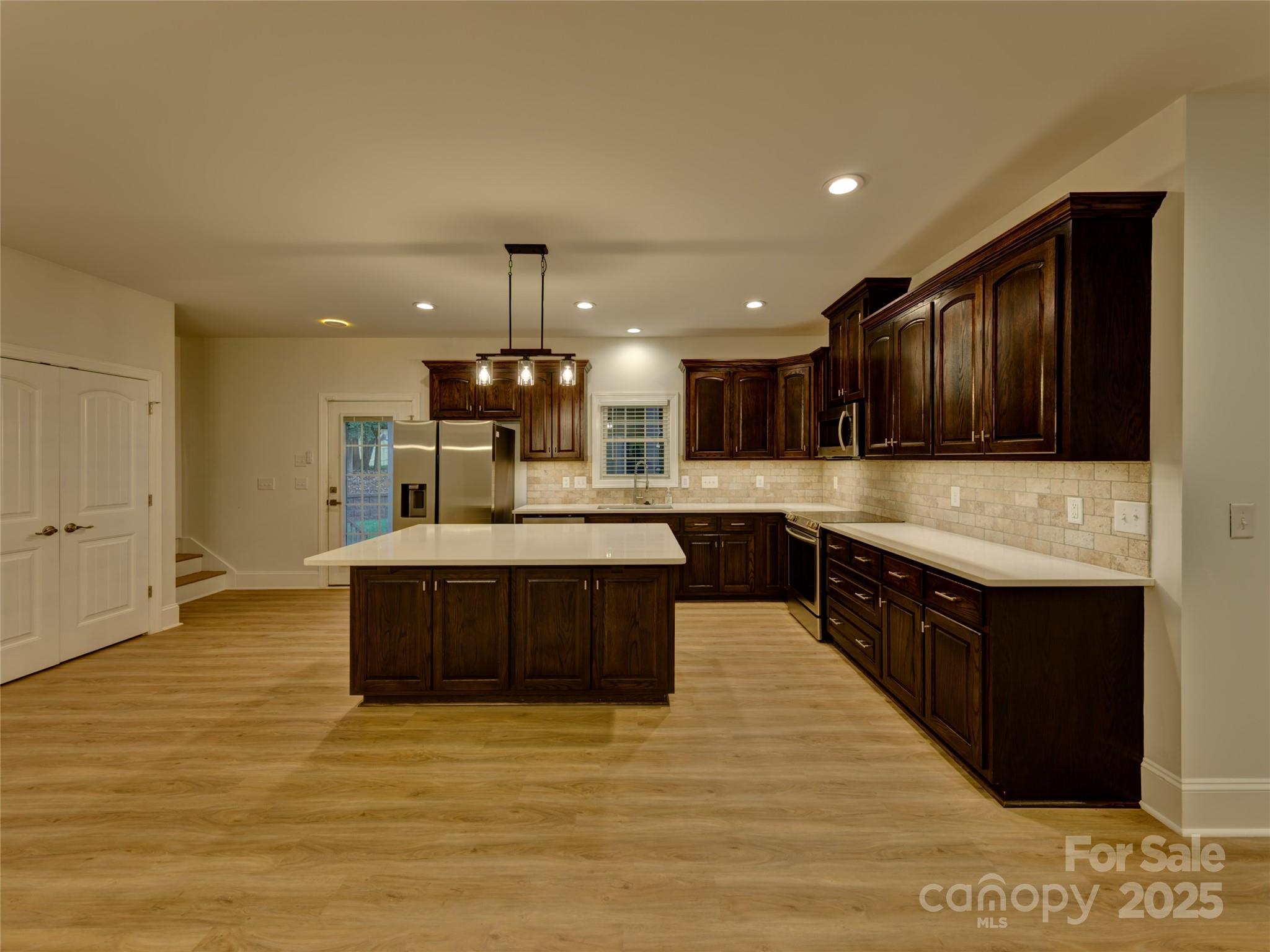 206 Montclair Drive Locust, NC 28097 - Photo 17 of 46 a large kitchen with stainless steel appliances kitchen island granite countertop a large counter top and stove