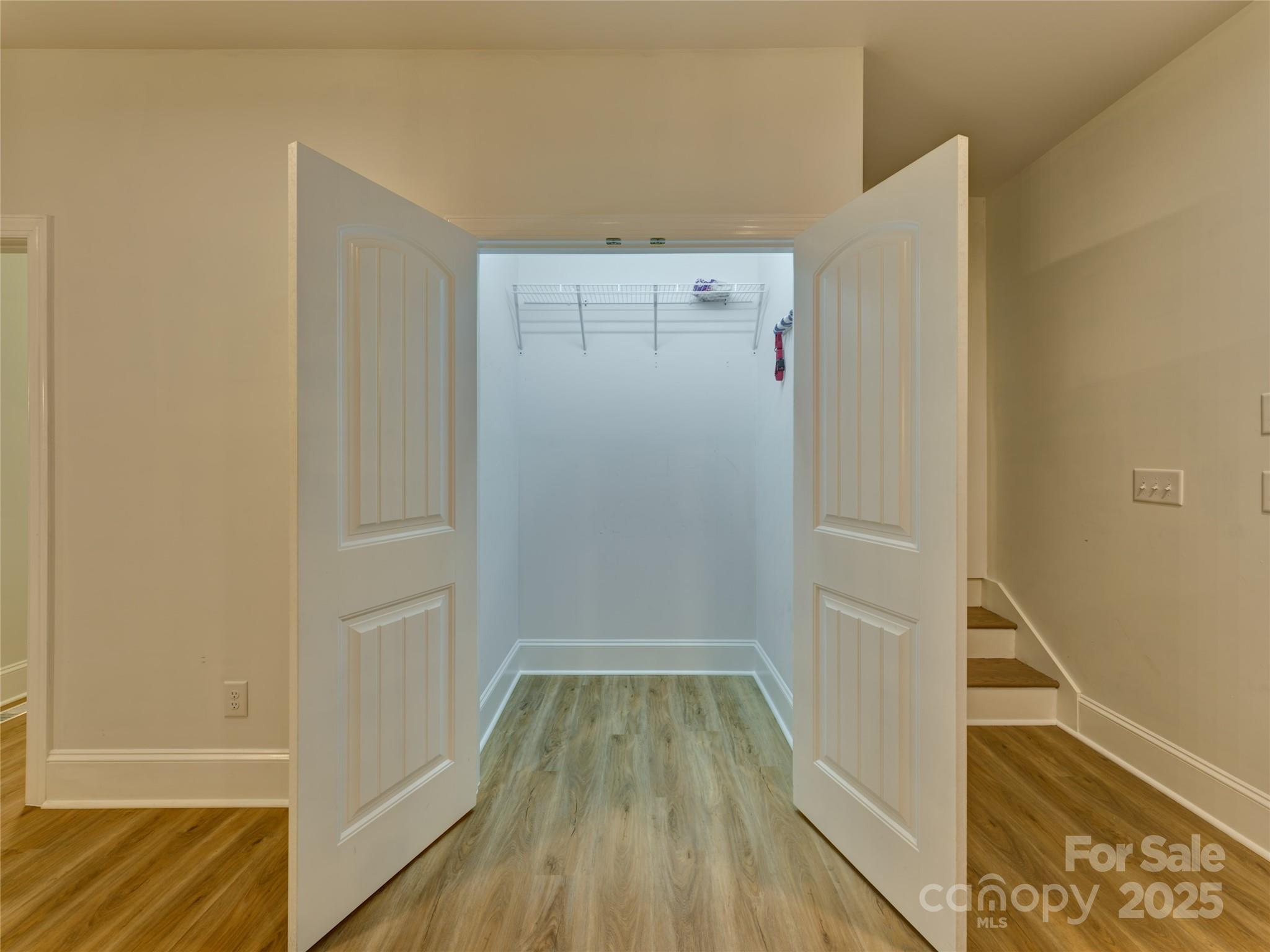 206 Montclair Drive Locust, NC 28097 - Photo 18 of 46 a view of walk in closet with wooden floor