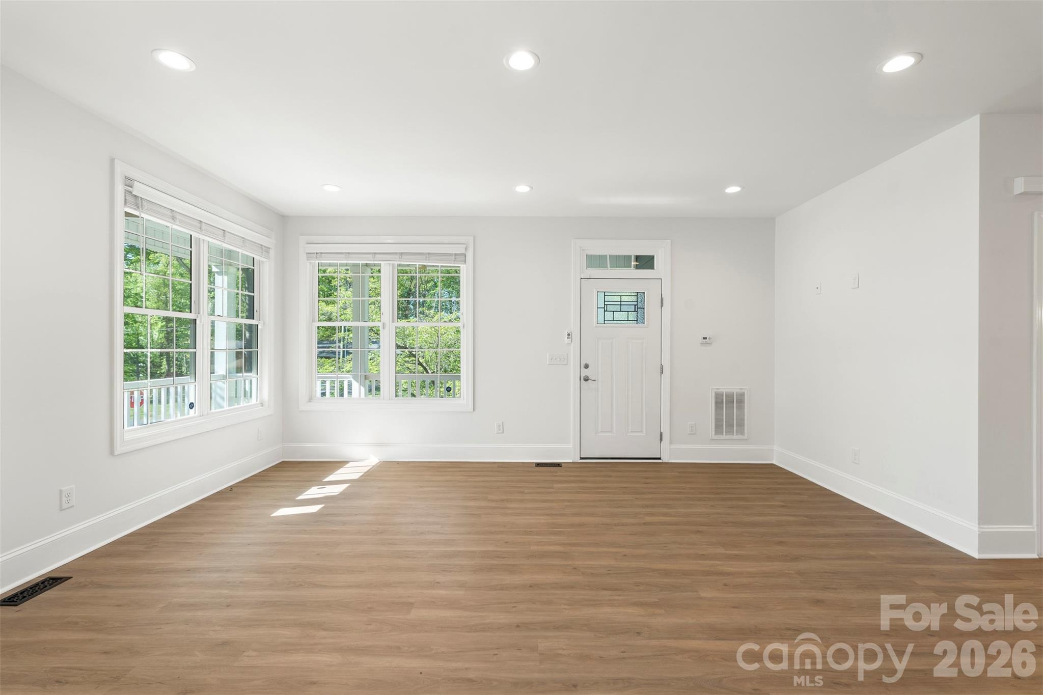 206 Montclair Drive Locust, NC 28097 - Photo 18 of 40 a view of an empty room with wooden floor and a window