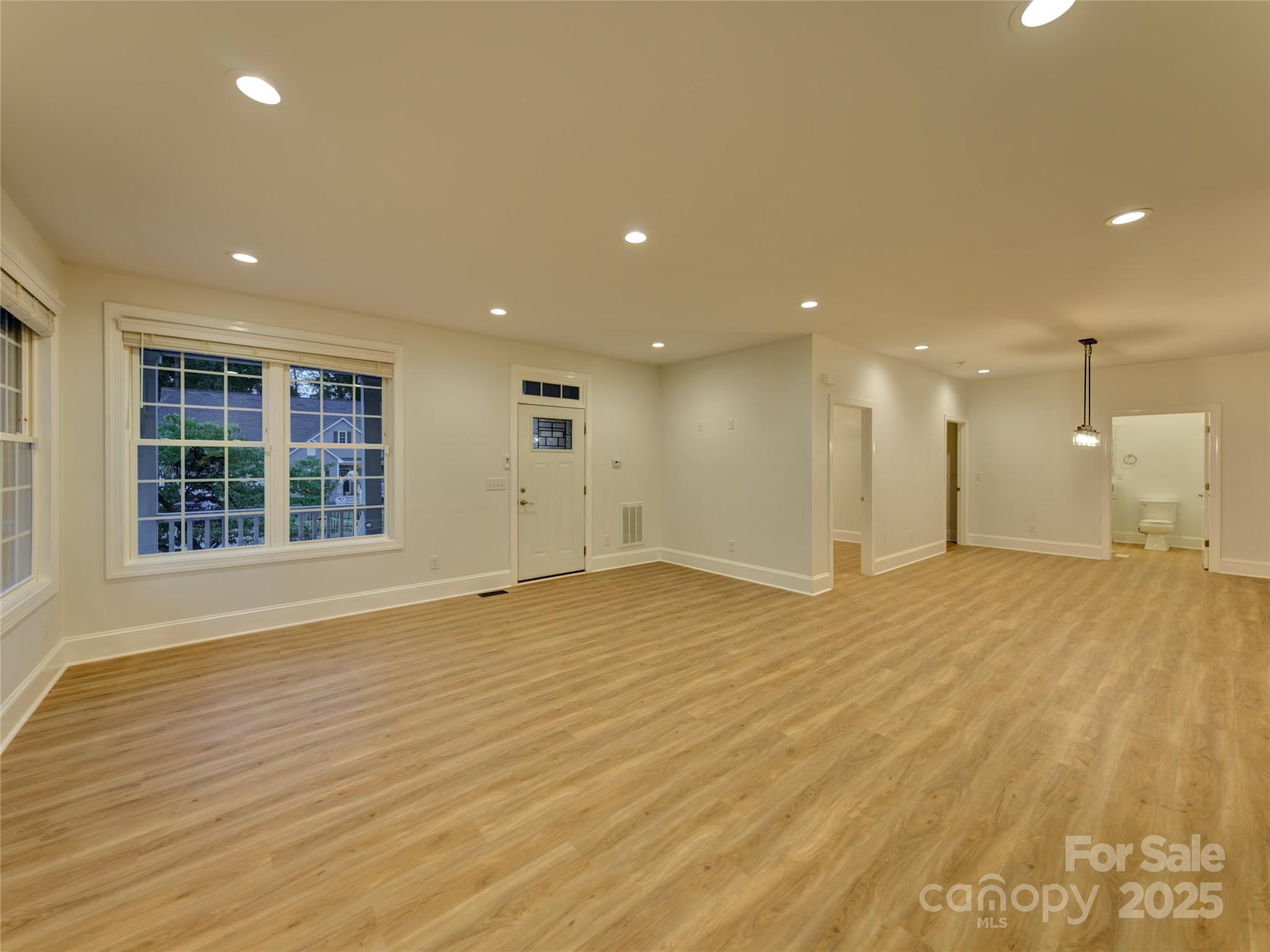 206 Montclair Drive Locust, NC 28097 - Photo 20 of 46 a view of an empty room with wooden floor and a window