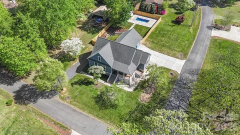 an aerial view of a house with garden space and street view