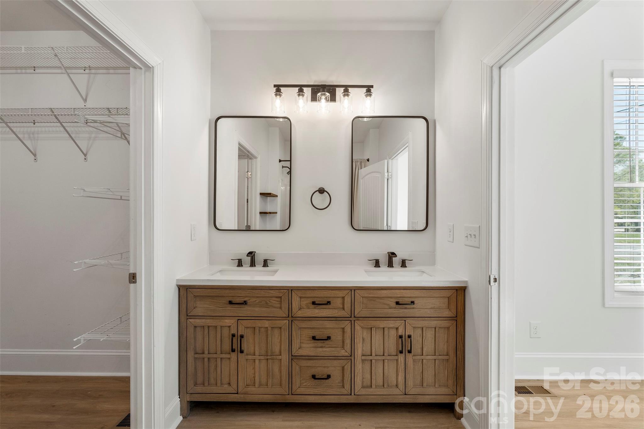 206 Montclair Drive Locust, NC 28097 - Photo 22 of 40 a bathroom with double vanity sinks and a mirror