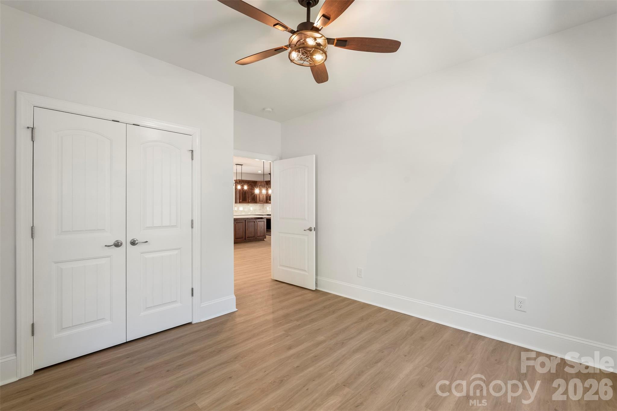 206 Montclair Drive Locust, NC 28097 - Photo 25 of 40 a view of a room with wooden floor and a ceiling fan