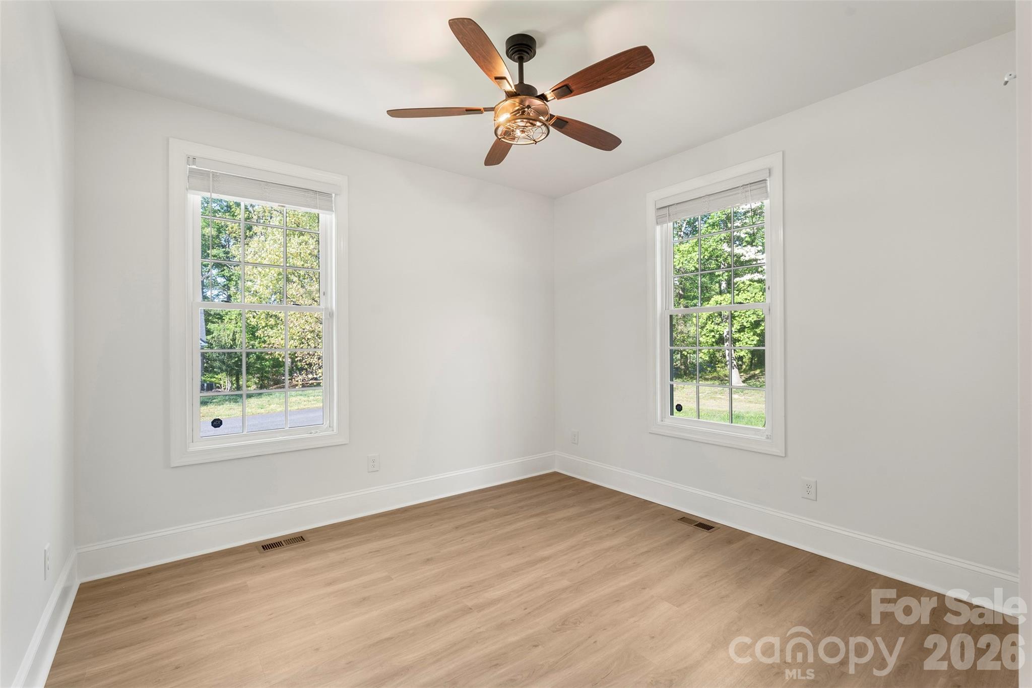 206 Montclair Drive Locust, NC 28097 - Photo 26 of 40 an empty room with wooden floor and windows