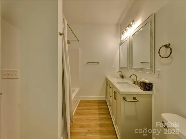 a bathroom with a granite countertop toilet and a sink