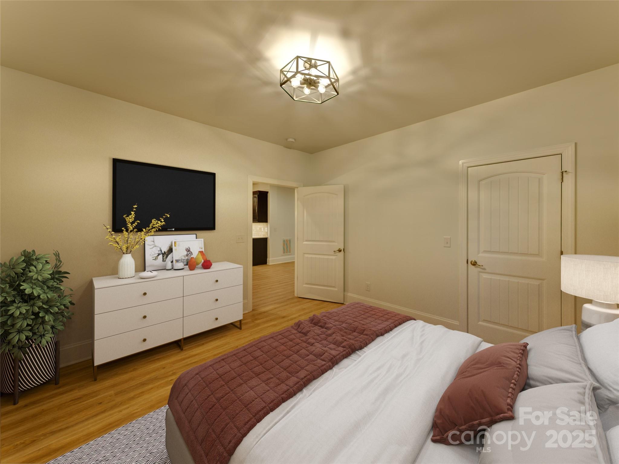 206 Montclair Drive Locust, NC 28097 - Photo 29 of 46 a bedroom with a bed and a flat screen tv