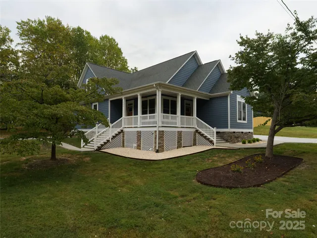a view of backyard with seating area and trees
