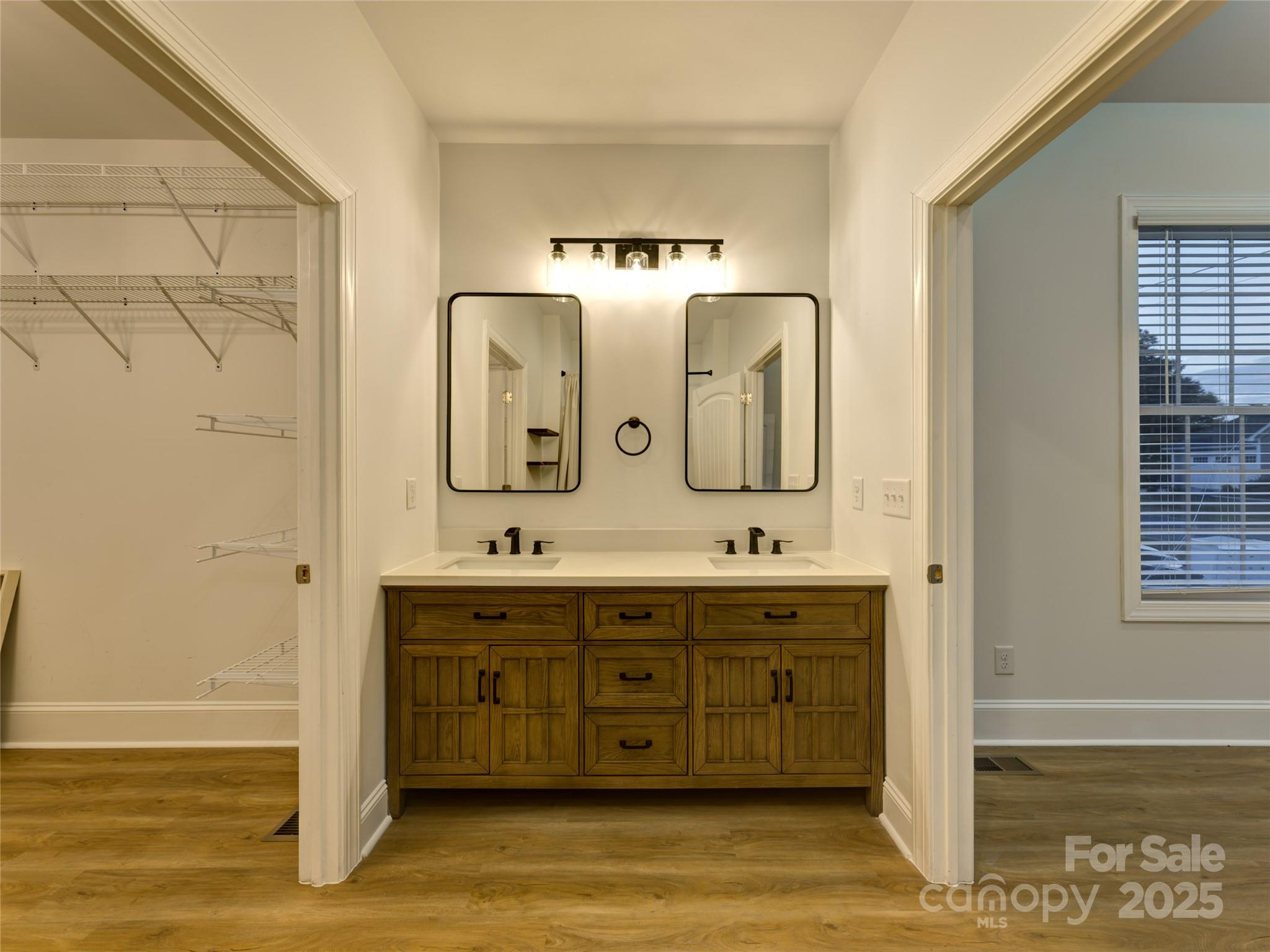 206 Montclair Drive Locust, NC 28097 - Photo 32 of 46 a spacious bathroom with a double vanity sink and a mirror
