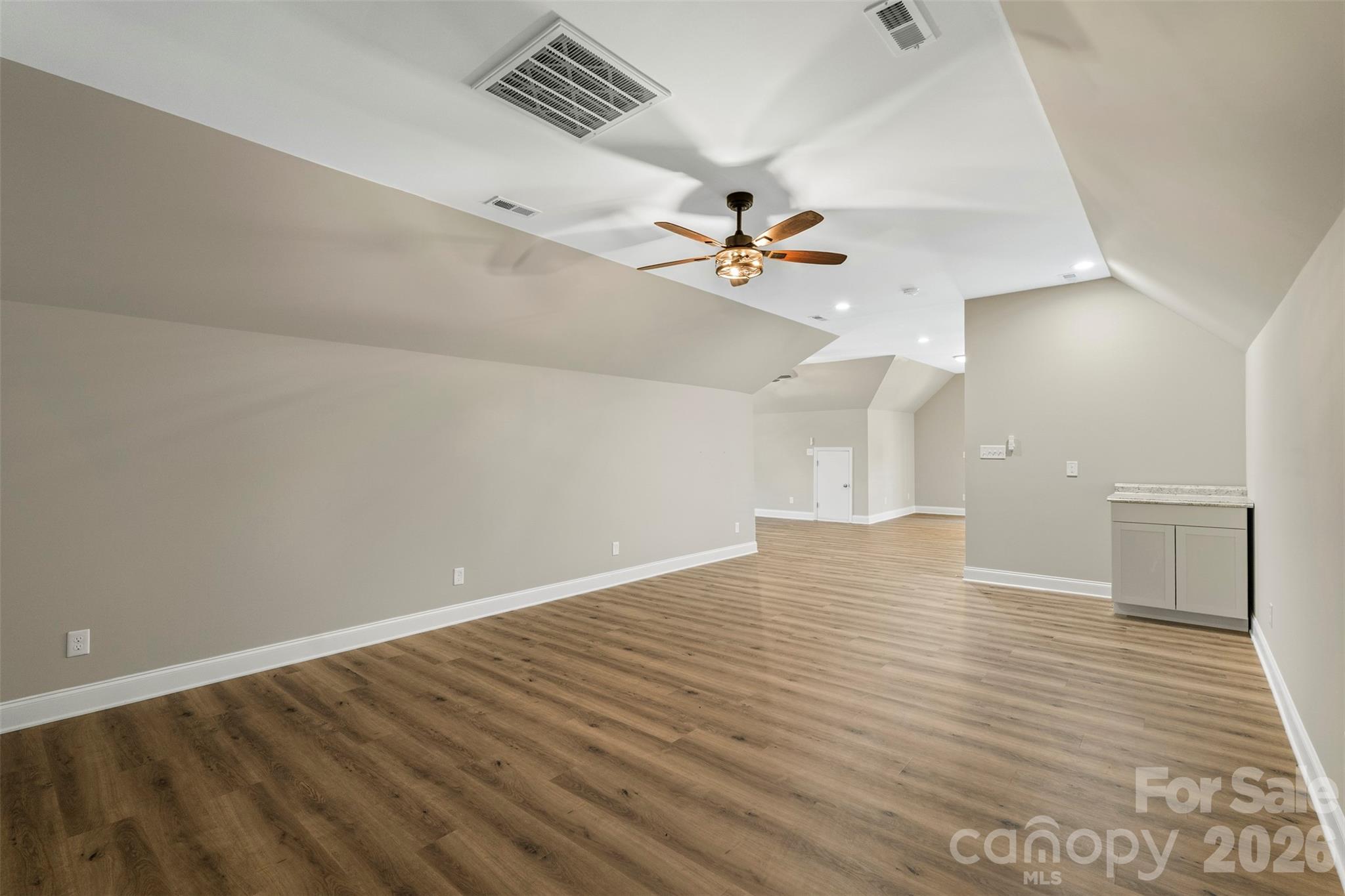 206 Montclair Drive Locust, NC 28097 - Photo 35 of 40 an empty room with wooden floor and fan