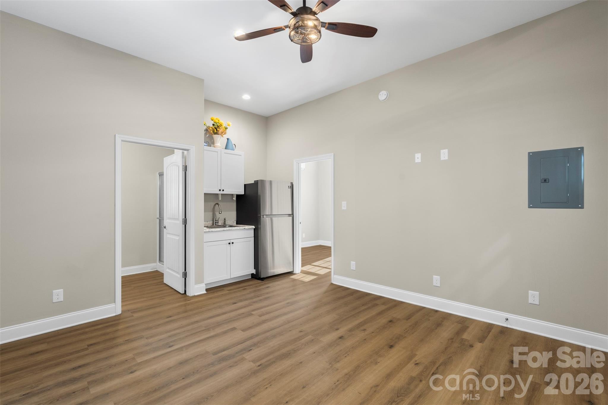206 Montclair Drive Locust, NC 28097 - Photo 37 of 40 a view of a kitchen with a refrigerator a ceiling fan and wooden floor
