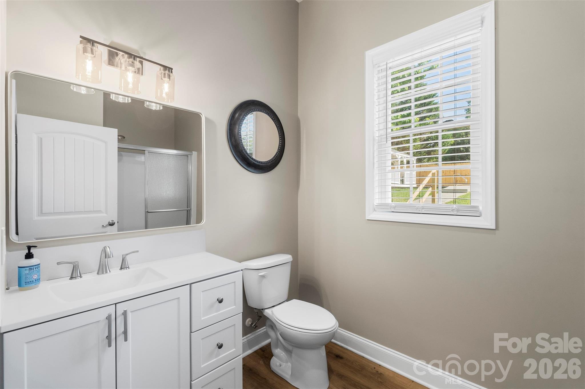206 Montclair Drive Locust, NC 28097 - Photo 40 of 40 a bathroom with a toilet a sink a vanity and mirror