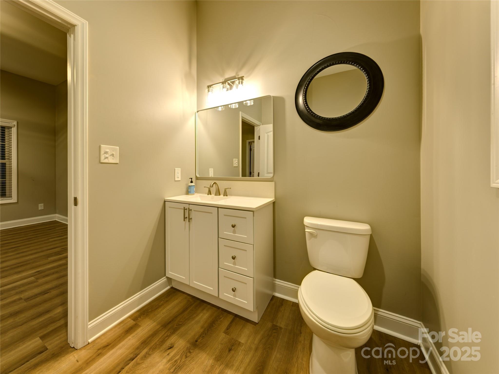 206 Montclair Drive Locust, NC 28097 - Photo 44 of 46 a bathroom with a granite countertop toilet and a sink