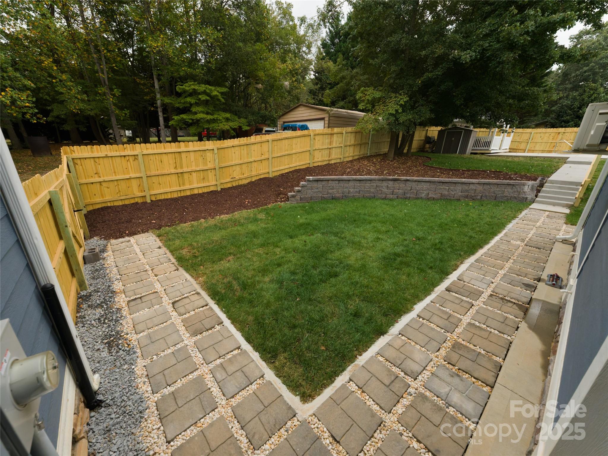 206 Montclair Drive Locust, NC 28097 - Photo 8 of 46 a view of backyard with seating area and trees
