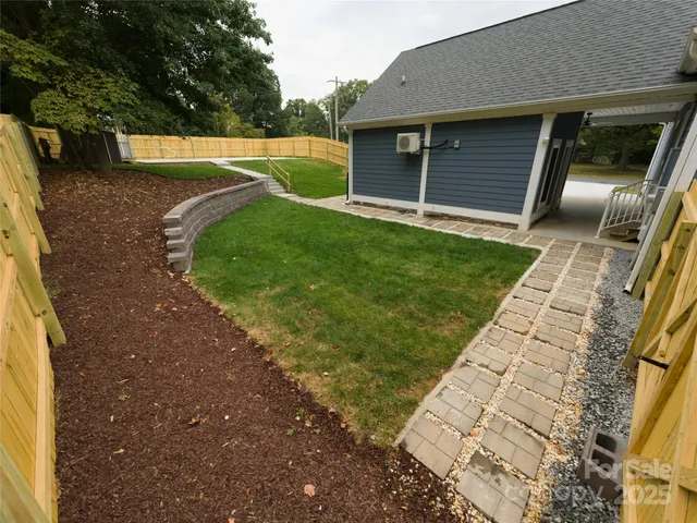 a large kitchen with stainless steel appliances kitchen island granite countertop a large counter top and stove