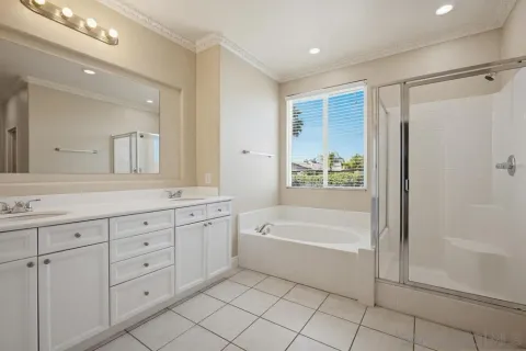 a spacious bathroom with a tub sink and mirror