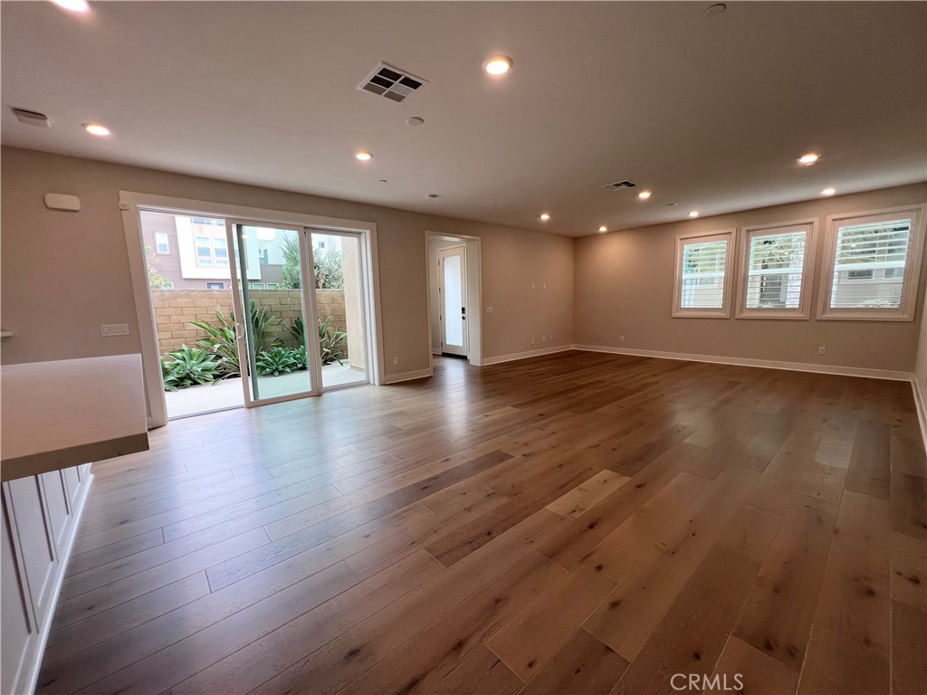 108 Chorus Irvine, CA 92618 - Photo 11 of 39 an empty room with wooden floor and windows