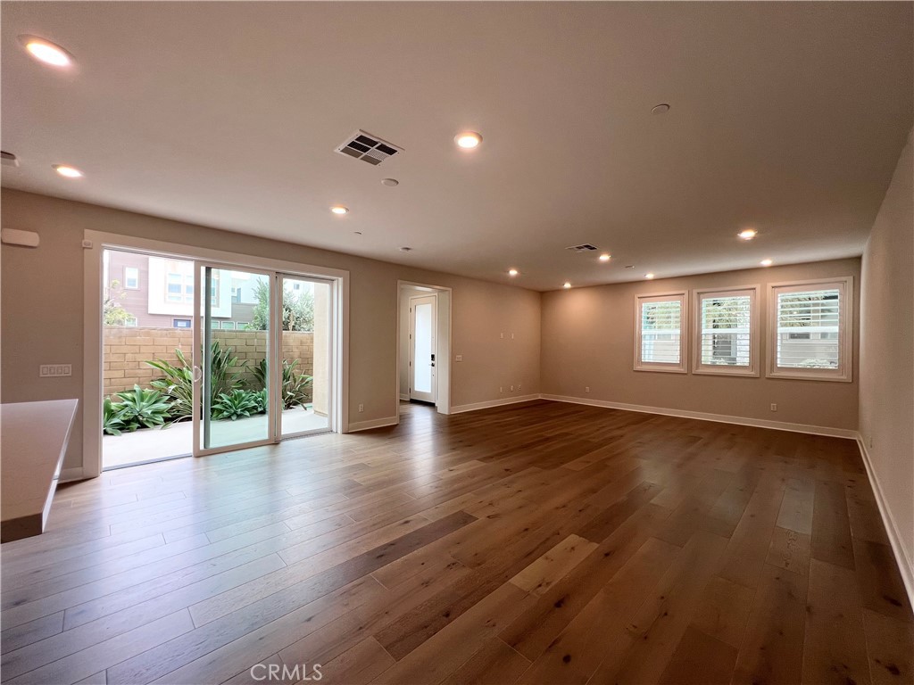 108 Chorus Irvine, CA 92618 - Photo 12 of 39 an empty room with wooden floor and windows