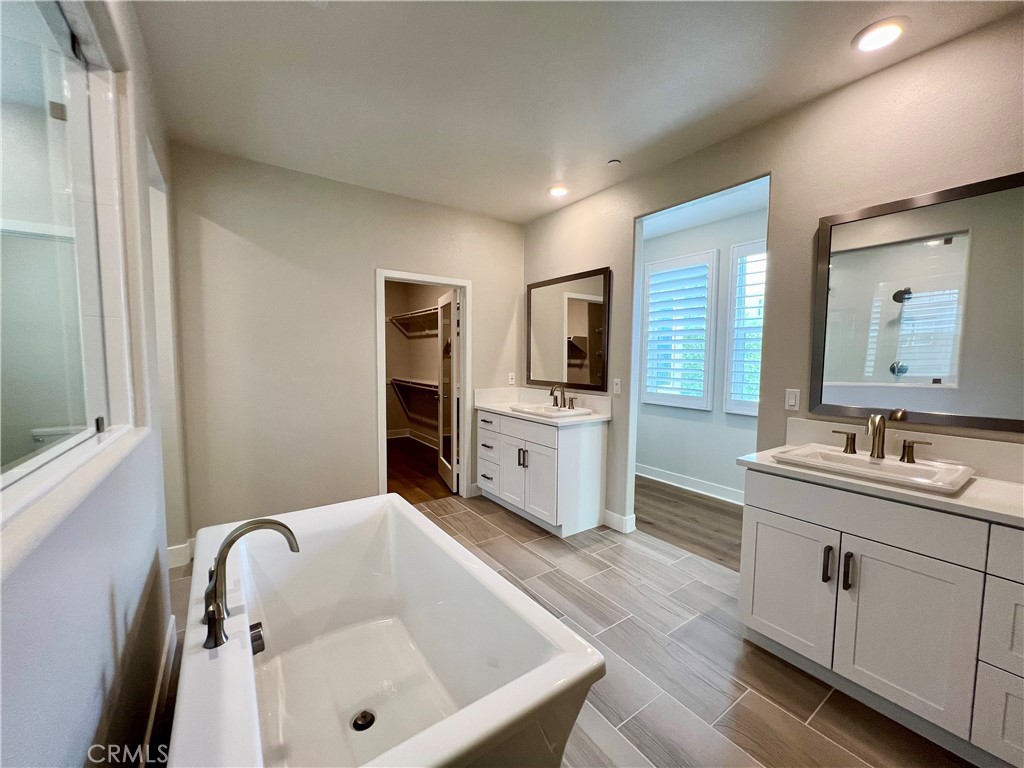 108 Chorus Irvine, CA 92618 - Photo 16 of 39 a bathroom with a tub sink and mirror