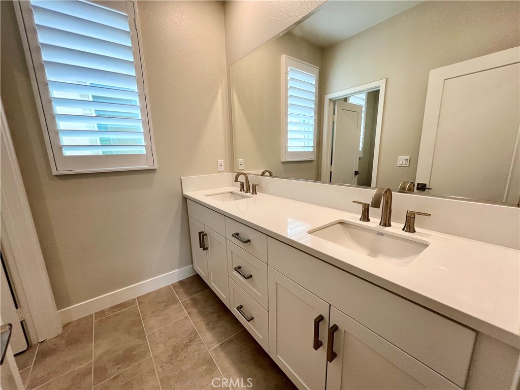 108 Chorus Irvine, CA 92618 - Photo 23 of 39 a bathroom with a granite countertop sink and a mirror
