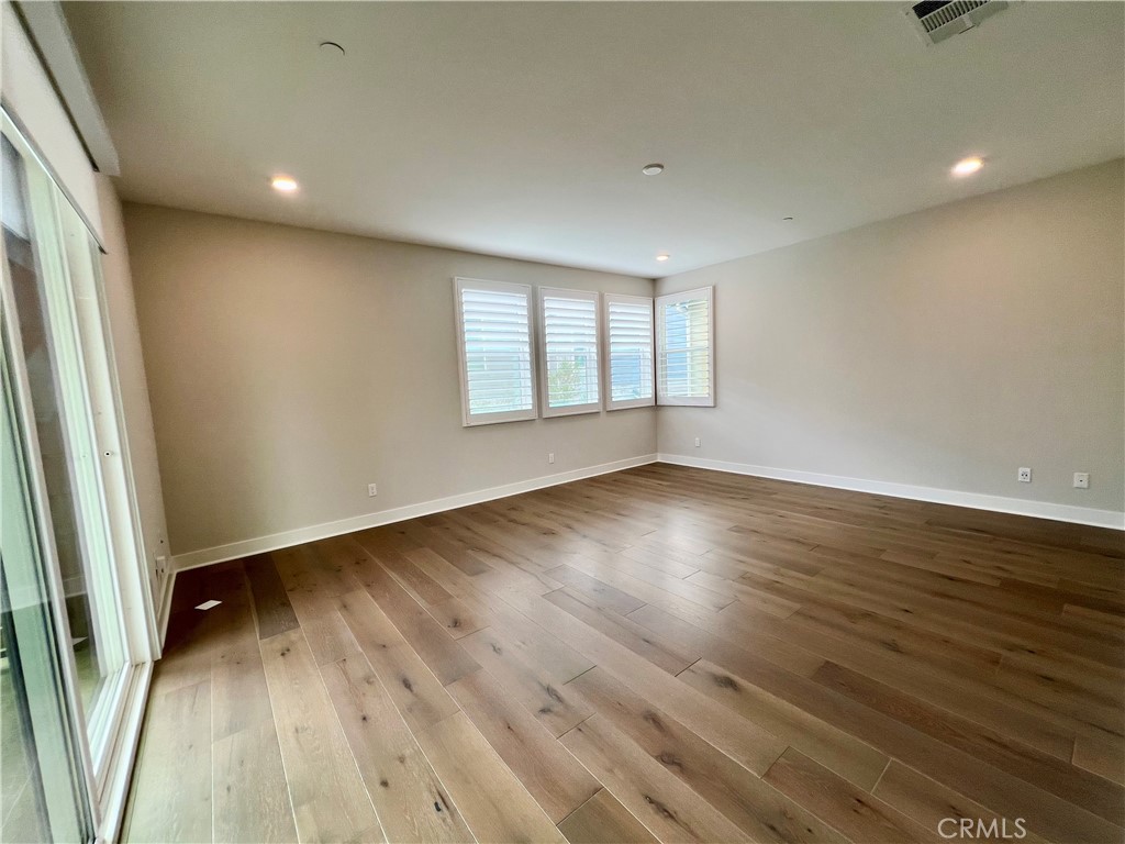 108 Chorus Irvine, CA 92618 - Photo 24 of 39 an empty room with wooden floor and windows