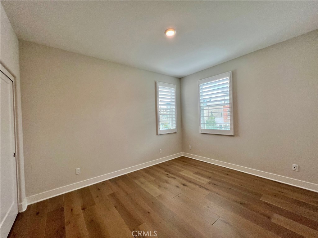 108 Chorus Irvine, CA 92618 - Photo 25 of 39 an empty room with wooden floor and windows