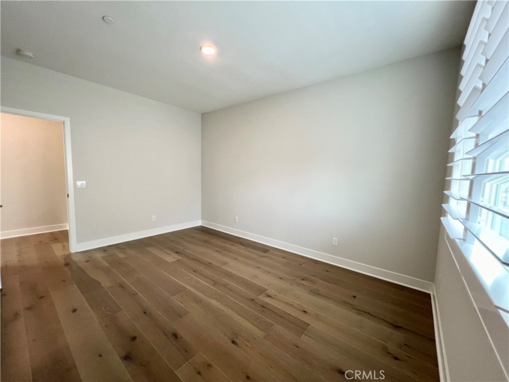 108 Chorus Irvine, CA 92618 - Photo 28 of 39 an empty room with wooden floor and windows